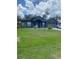 Charming single-story home with well-manicured lawn, stylish paint, and attached garage at 2122 Orange Tree Dr, Edgewater, FL 32141