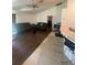 Bright living room with hardwood flooring, tile transition, and comfortable furnishings at 2122 Orange Tree Dr, Edgewater, FL 32141