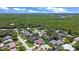 Aerial view of home in a neighborhood with lush landscaping and waterways at 22 Sand Dune Dr, New Smyrna Beach, FL 32169