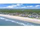 Expansive ocean view showcasing a row of beachside homes in a vibrant coastal community with serene ocean backdrop at 22 Sand Dune Dr, New Smyrna Beach, FL 32169