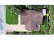 Aerial view of home with lush landscaping and driveway, roof, and patio area at 22 Sand Dune Dr, New Smyrna Beach, FL 32169