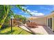 Inviting backyard patio with comfortable seating, perfect for outdoor dining and relaxation amidst lush landscaping at 22 Sand Dune Dr, New Smyrna Beach, FL 32169