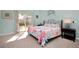 Comfortable bedroom with sliding glass door leading to fenced in back yard at 22 Sand Dune Dr, New Smyrna Beach, FL 32169