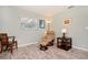 Small bedroom featuring laminate floors, a beige recliner, and a dark wooden end table at 22 Sand Dune Dr, New Smyrna Beach, FL 32169