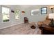 Small bedroom featuring laminate floors, a beige recliner, and bright natural light at 22 Sand Dune Dr, New Smyrna Beach, FL 32169