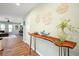 Stylish entryway features a unique console table with decorative accents and wood-look floors, creating a welcoming ambiance at 22 Sand Dune Dr, New Smyrna Beach, FL 32169