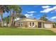 Charming single story home with stone facade, lawn, and driveway at 22 Sand Dune Dr, New Smyrna Beach, FL 32169
