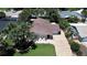Exterior elevation showcasing brick accents, a well-manicured lawn, and a paved driveway at 22 Sand Dune Dr, New Smyrna Beach, FL 32169