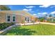 Stone facade home features a small patio area, lovely landscaping and well-maintained lawn at 22 Sand Dune Dr, New Smyrna Beach, FL 32169
