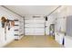 Clean and organized garage space with ample storage, shelving, and tools for household projects and vehicle parking at 22 Sand Dune Dr, New Smyrna Beach, FL 32169
