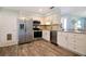 Well-appointed kitchen with stainless steel appliances, white cabinetry, and modern countertops, offering functionality and style at 22 Sand Dune Dr, New Smyrna Beach, FL 32169