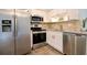 Modern kitchen featuring stainless steel appliances, granite countertops, and wooden floors at 22 Sand Dune Dr, New Smyrna Beach, FL 32169