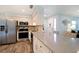 Well-appointed kitchen featuring stainless steel appliances, granite countertops, and seamless flow to the entryway at 22 Sand Dune Dr, New Smyrna Beach, FL 32169