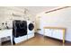 Laundry room with a sink, white cabinets, and a modern washer and dryer at 22 Sand Dune Dr, New Smyrna Beach, FL 32169