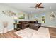 Cozy living room featuring a plush leather sectional, modern decor, and ample natural light enhancing the relaxing ambiance at 22 Sand Dune Dr, New Smyrna Beach, FL 32169