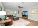 Inviting living room featuring a comfortable leather sectional, ceiling fan, and stylish decor, perfect for relaxation at 22 Sand Dune Dr, New Smyrna Beach, FL 32169