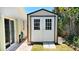 Backyard shed with sliding doors on a brick path between two buildings at 22 Sand Dune Dr, New Smyrna Beach, FL 32169
