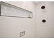 Modern walk-in shower with sleek fixtures, textured tile walls, and built-in niche, offering a spa-like experience at 22 Sand Dune Dr, New Smyrna Beach, FL 32169