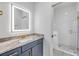 This bathroom features a bright mirror, stylish vanity, granite countertop, and a glass door shower at 2324 Orange Tree Dr, Edgewater, FL 32141
