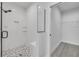 Bright bathroom showcasing glass-enclosed shower, mosaic tile floor, and a spacious, organized walk-in closet at 2324 Orange Tree Dr, Edgewater, FL 32141