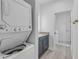 Bathroom featuring a washer and dryer, stylish vanity, granite countertop, and a glass door shower at 2324 Orange Tree Dr, Edgewater, FL 32141