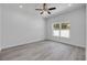 Bedroom featuring modern ceiling fan, large window, and light gray flooring at 2324 Orange Tree Dr, Edgewater, FL 32141