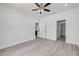 Bedroom featuring modern ceiling fan, light gray flooring, and access to walk-in closet at 2324 Orange Tree Dr, Edgewater, FL 32141