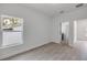 Bright bedroom with laminate flooring, natural light, and hallway views at 2324 Orange Tree Dr, Edgewater, FL 32141