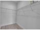 Spacious walk-in closet with white wire shelving and gray wood-look flooring at 2324 Orange Tree Dr, Edgewater, FL 32141