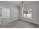 Dining room featuring modern hanging light fixture, large window, and access to sliding glass door at 2324 Orange Tree Dr, Edgewater, FL 32141