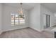 Dining room featuring modern hanging light fixture, large window, and access to sliding glass door at 2324 Orange Tree Dr, Edgewater, FL 32141