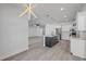 Bright, modern kitchen with stainless steel appliances, gray cabinets, and island with sink at 2324 Orange Tree Dr, Edgewater, FL 32141