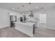Open kitchen featuring a center island with quartz countertops and stainless steel appliances at 2324 Orange Tree Dr, Edgewater, FL 32141