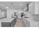 Bright modern kitchen featuring an island with sink, and white cabinets with stainless appliances at 2324 Orange Tree Dr, Edgewater, FL 32141
