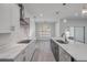 Long kitchen island with seating, stainless steel dishwasher, and modern pendant lighting at 2324 Orange Tree Dr, Edgewater, FL 32141