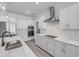 Kitchen featuring white cabinets, stainless appliances, an island with a sink, and luxury counter tops at 2324 Orange Tree Dr, Edgewater, FL 32141