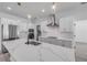 Close up of modern kitchen island with quartz countertop and pendant lighting at 2324 Orange Tree Dr, Edgewater, FL 32141