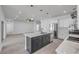 Bright, modern kitchen with stainless steel appliances, gray cabinets, and island with sink at 2324 Orange Tree Dr, Edgewater, FL 32141