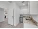 Elegant kitchenette boasts granite countertop, sink, and mini fridge for convenience and style at 2324 Orange Tree Dr, Edgewater, FL 32141