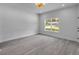 Bright living room featuring gray wood flooring and a large window allowing natural light at 2324 Orange Tree Dr, Edgewater, FL 32141