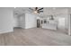 Spacious living room with modern ceiling fan, light gray flooring and open to the kitchen at 2324 Orange Tree Dr, Edgewater, FL 32141