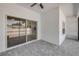 An outdoor patio with sliding glass doors looking into the kitchen. Includes paved floors and an outdoor ceiling fan at 2324 Orange Tree Dr, Edgewater, FL 32141