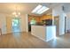 Well-lit kitchen with wood cabinets, a breakfast bar, and skylights providing ample natural light at 2548 Crestwood Ave, New Smyrna Beach, FL 32168