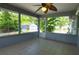 Enclosed porch with tiled floors and large windows offering views of the backyard and storage shed at 2548 Crestwood Ave, New Smyrna Beach, FL 32168