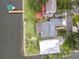 Waterfront property featuring a private dock, lush green lawns, and mature landscaping on a sunny day at 255 Lexington Dr, Daytona Beach, FL 32114
