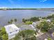 Scenic aerial showing residential waterfront homes with lush trees on the shoreline of a bay and a bridge at 255 Lexington Dr, Daytona Beach, FL 32114