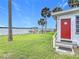 Home featuring a well-maintained backyard with waterfront and dock views at 255 Lexington Dr, Daytona Beach, FL 32114