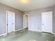 Bright bedroom featuring neutral walls, simple flooring, and two white doors at 255 Lexington Dr, Daytona Beach, FL 32114