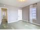 Bedroom featuring neutral walls, simple flooring, a white door, and a bright window at 255 Lexington Dr, Daytona Beach, FL 32114