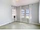 A bright bedroom featuring light-colored walls and multiple windows with curtains at 255 Lexington Dr, Daytona Beach, FL 32114